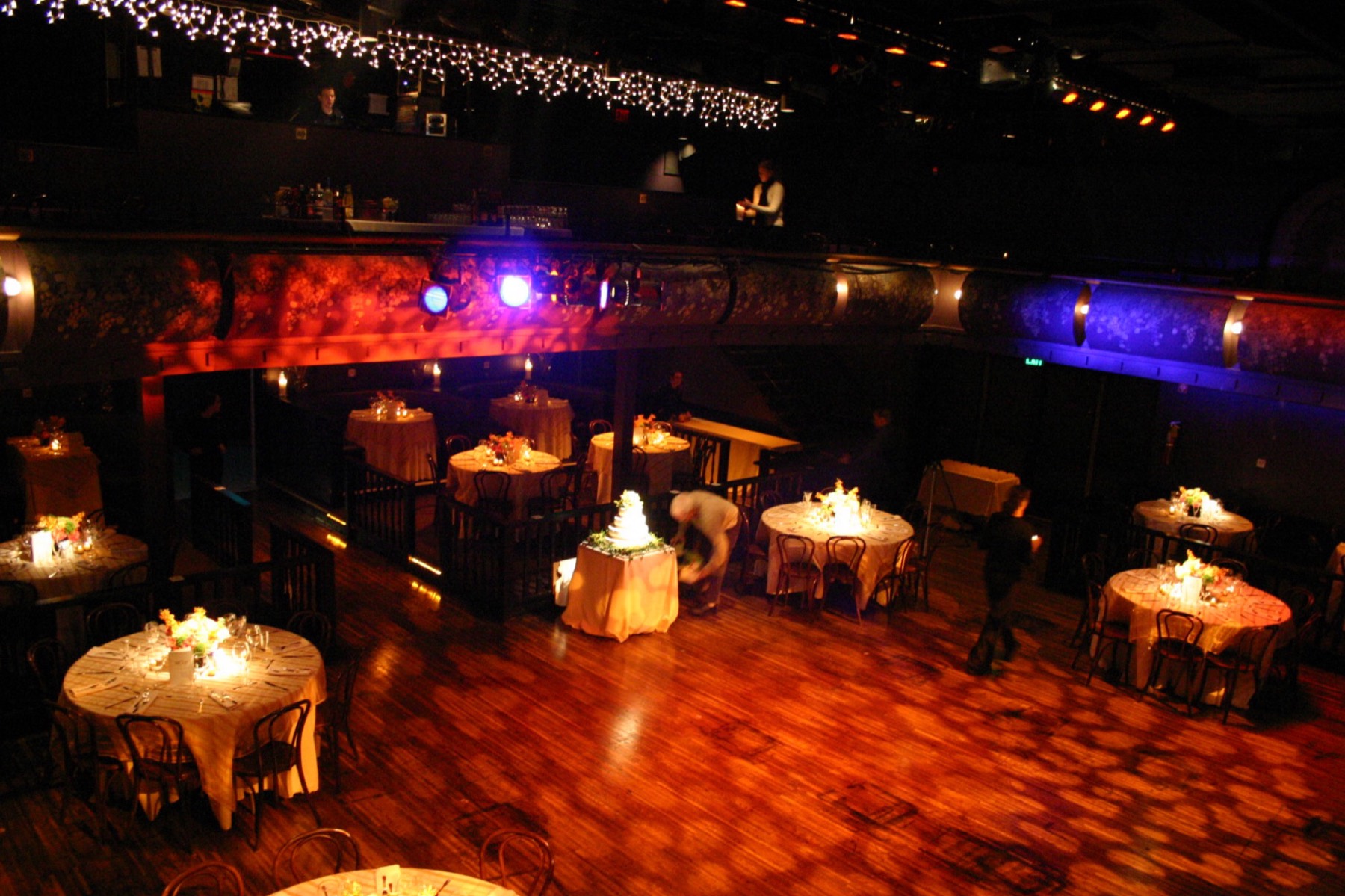 The Downtown Cabaret auditorium set with round tables and string lights for a private event